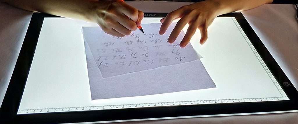 A light table used to copy a sketch onto another piece of paper using transparency.